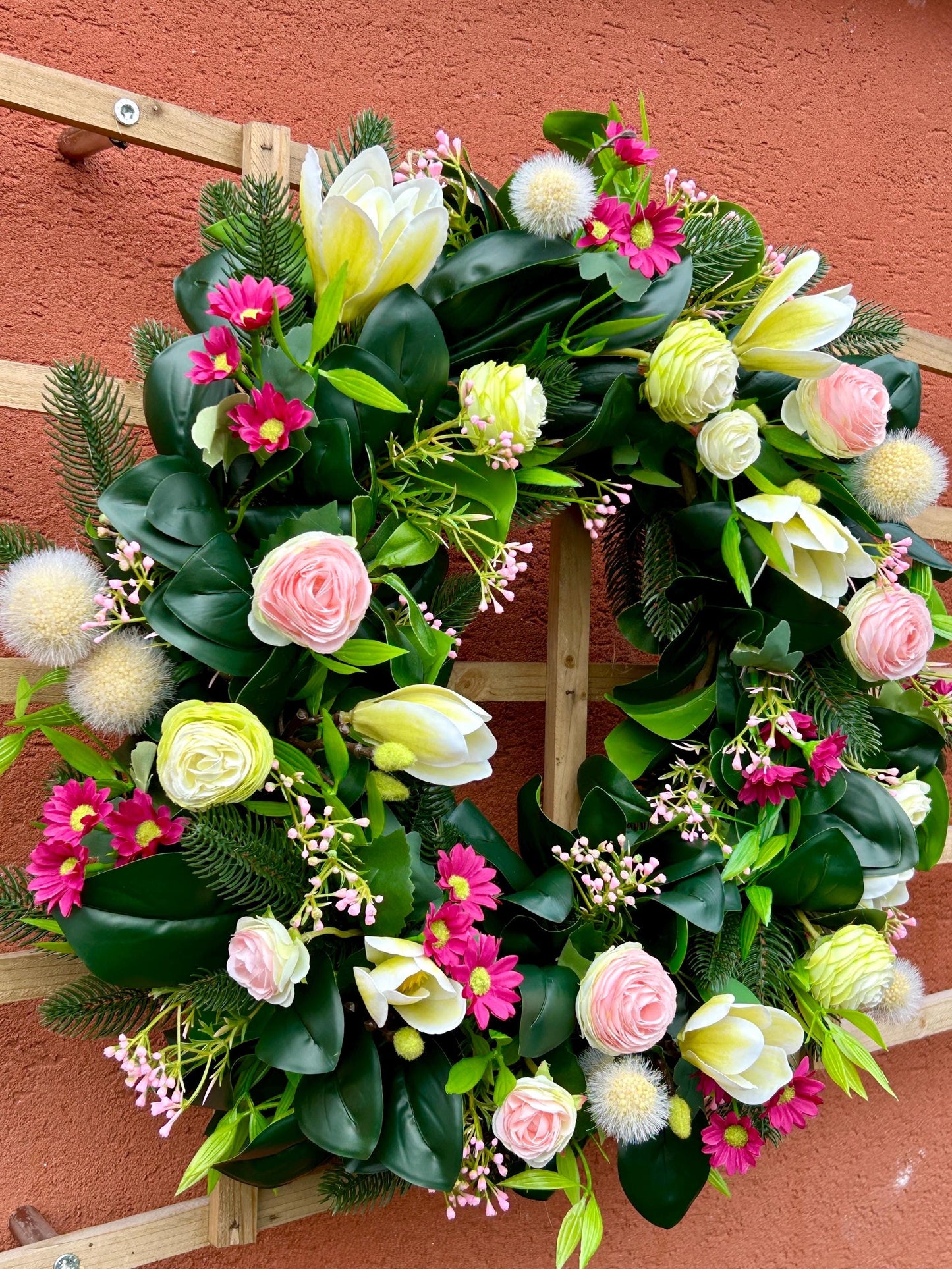 Couronne de printemps en plantes et de fleurs artificielles.